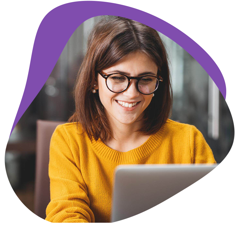 Young business woman in glasses looking at laptop